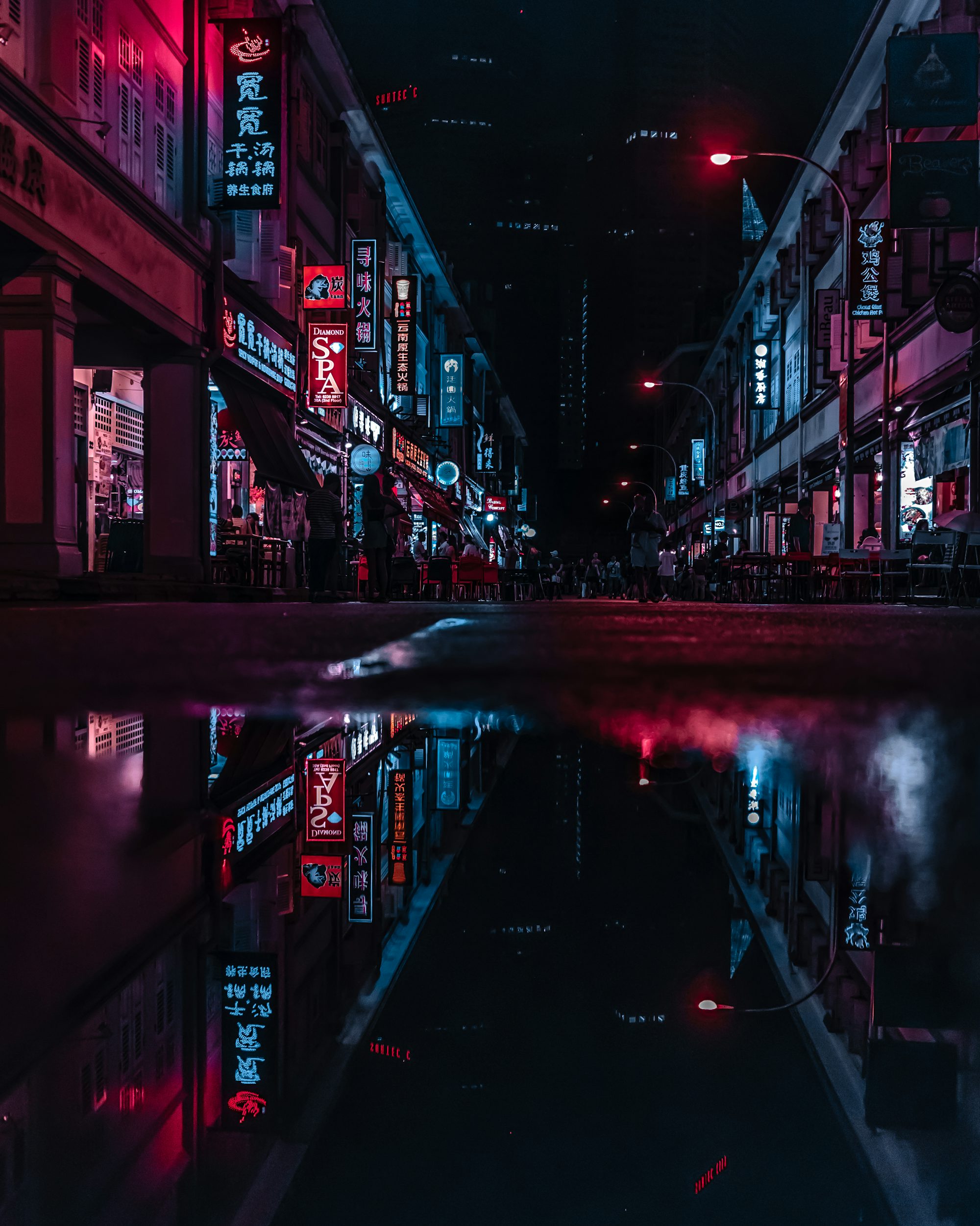 wet street in between building at night