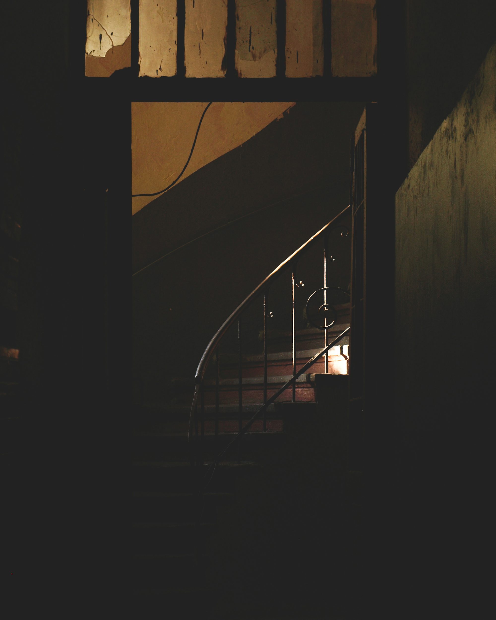 black metal staircase in dark room