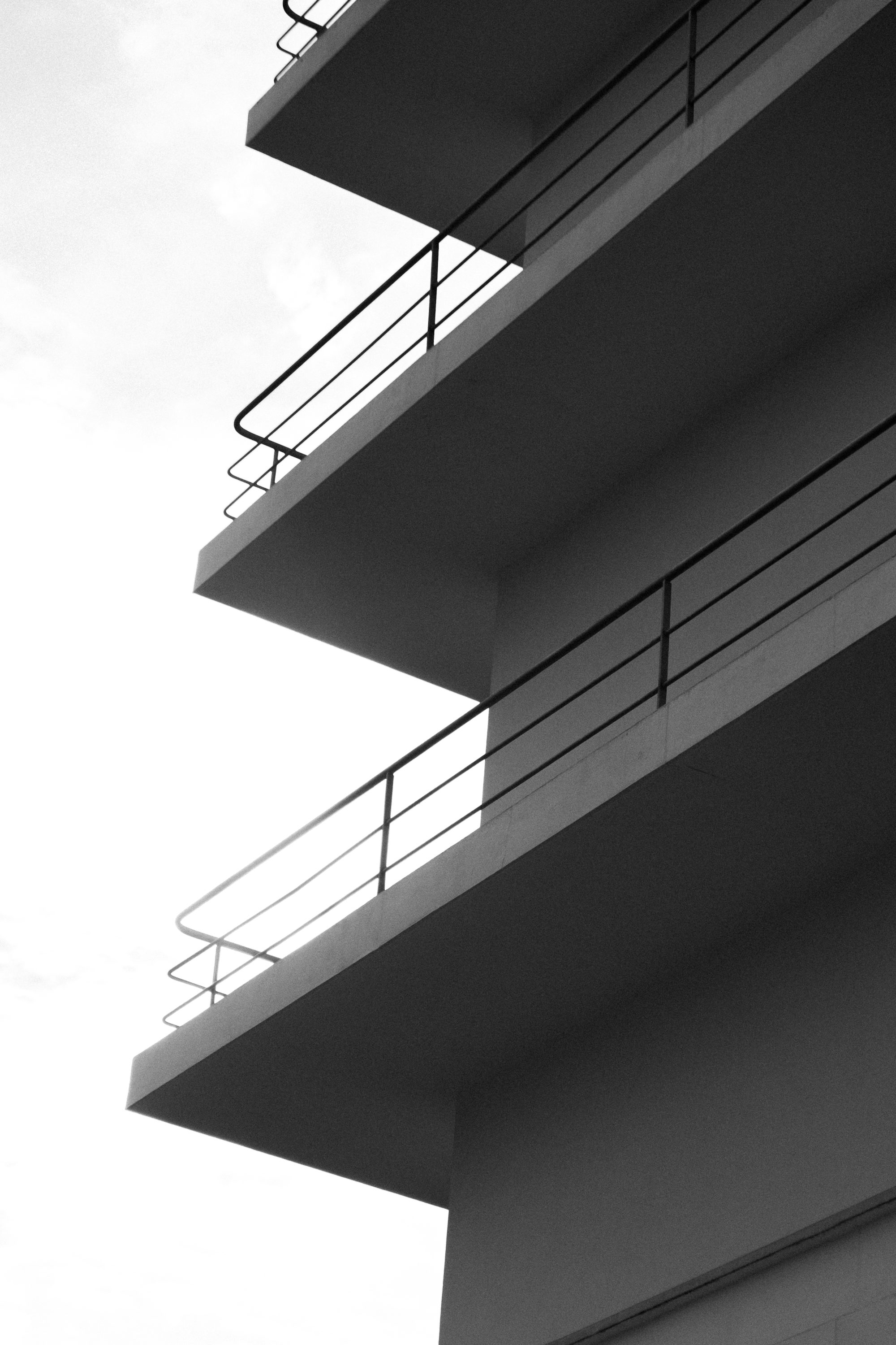 white concrete building with white metal railings