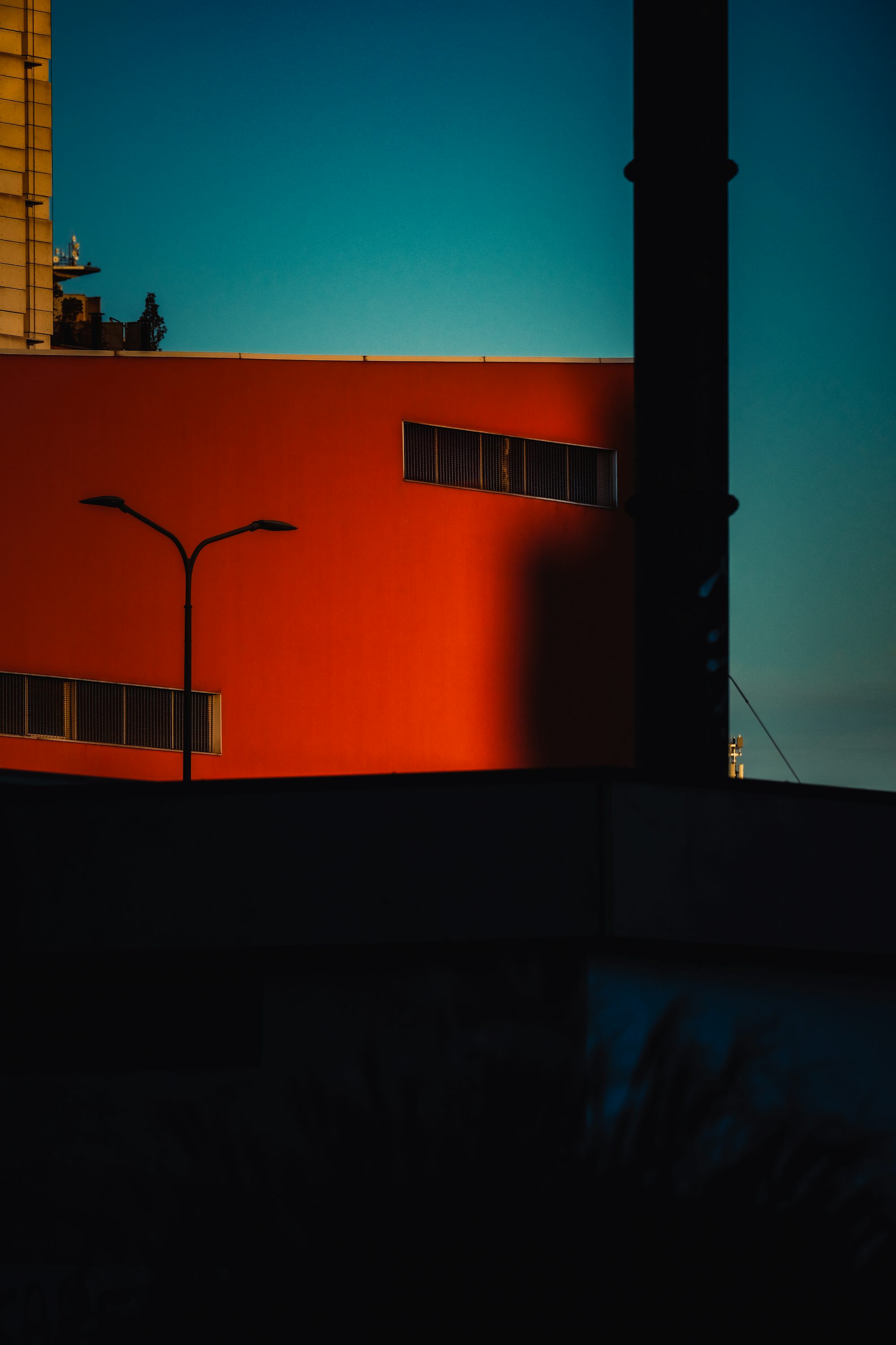 a red building with a street light in front of it