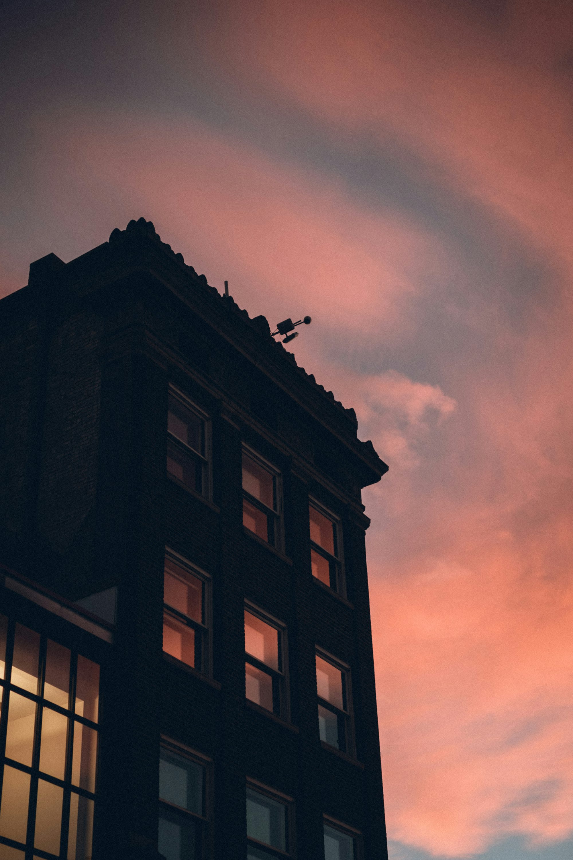a tall building with a sky in the background