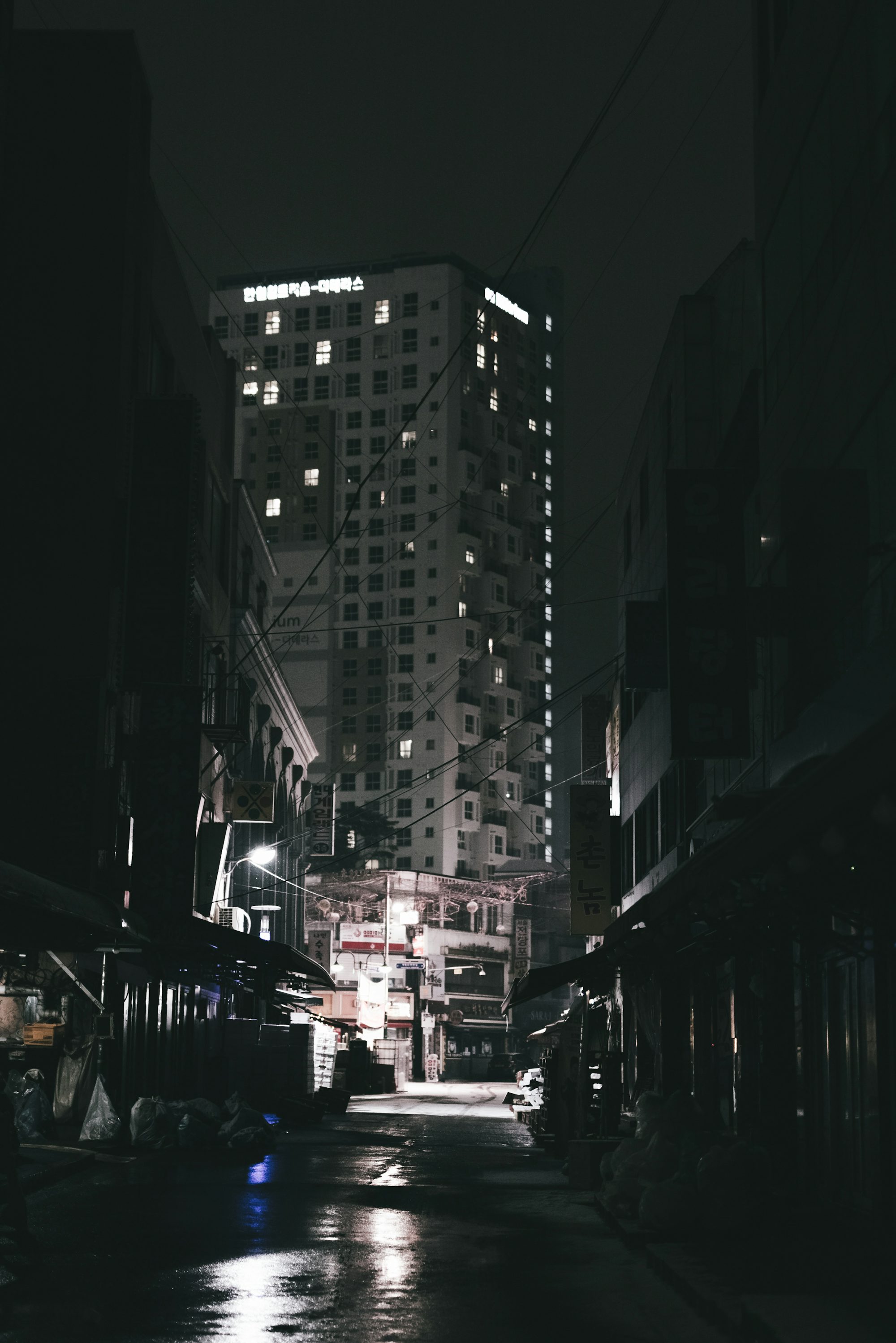 a city street at night with buildings lit up