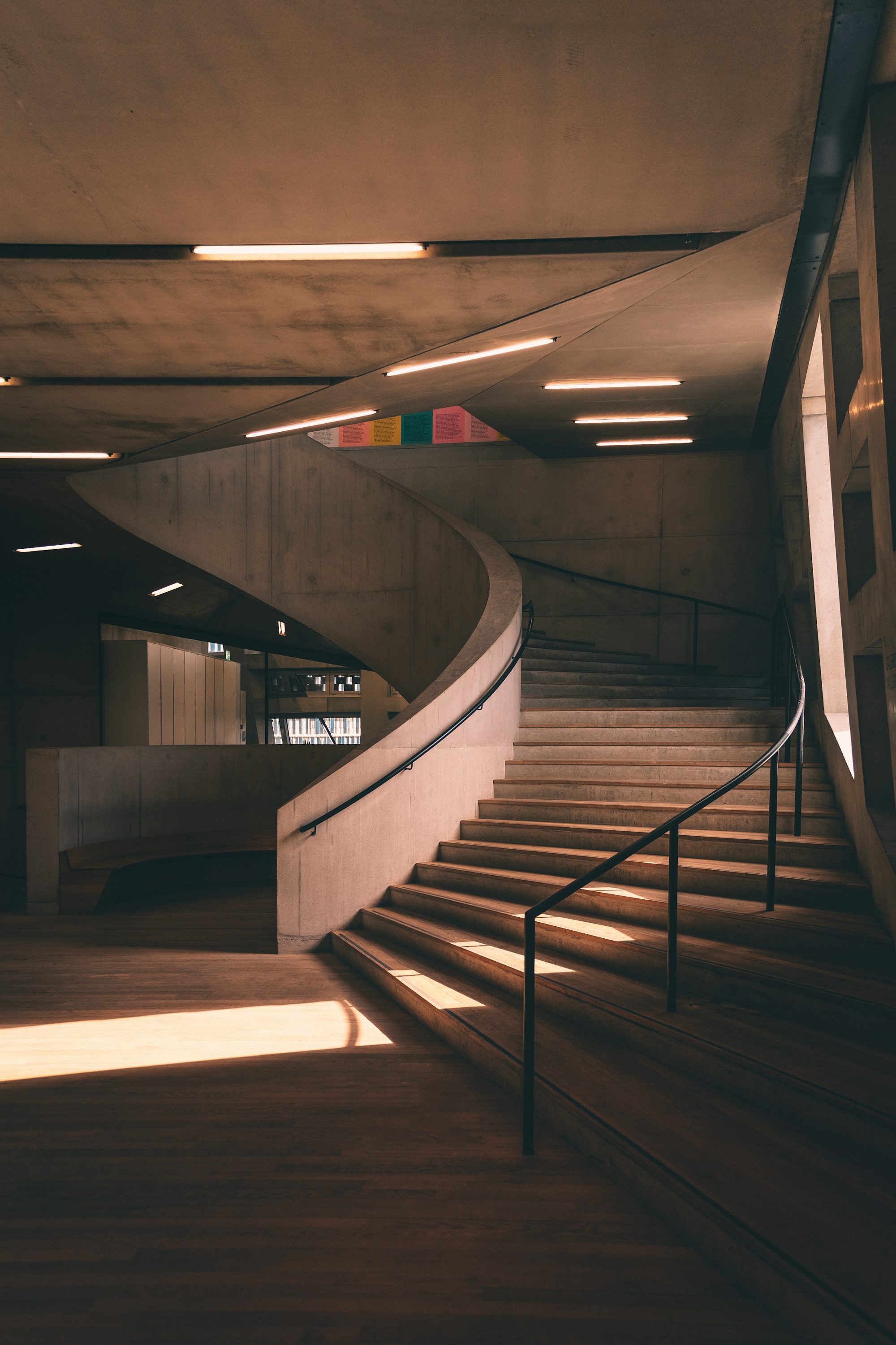 a staircase in a building with a light coming through