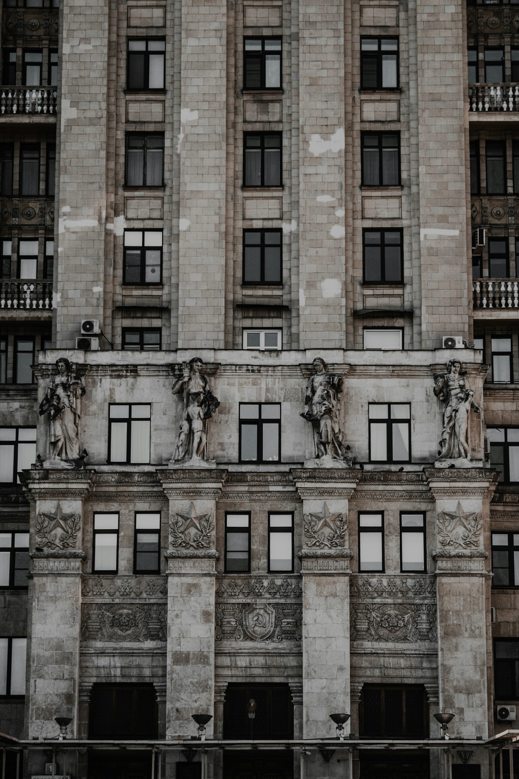 a very tall building with statues on the side of it