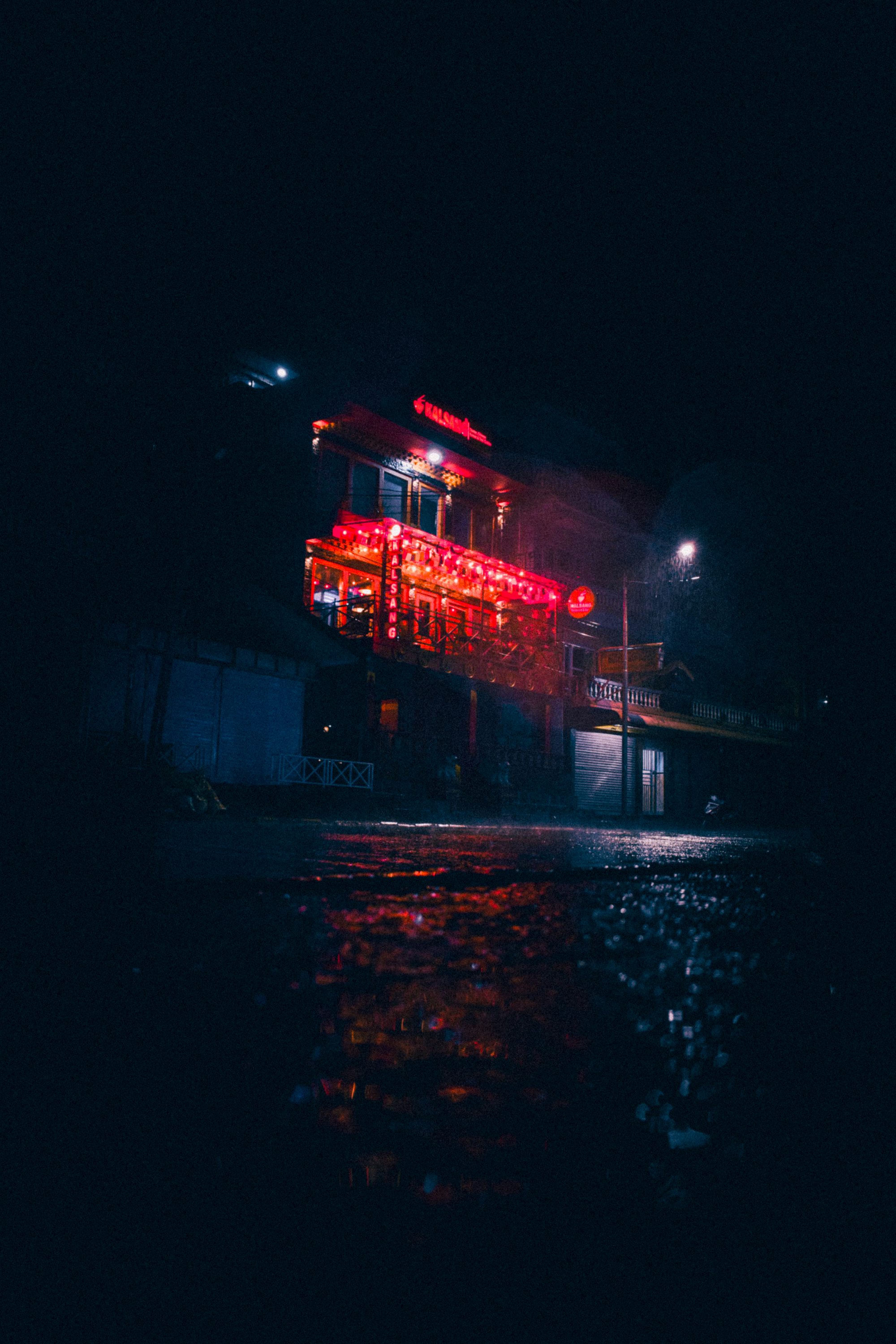 a building with red lights on it at night