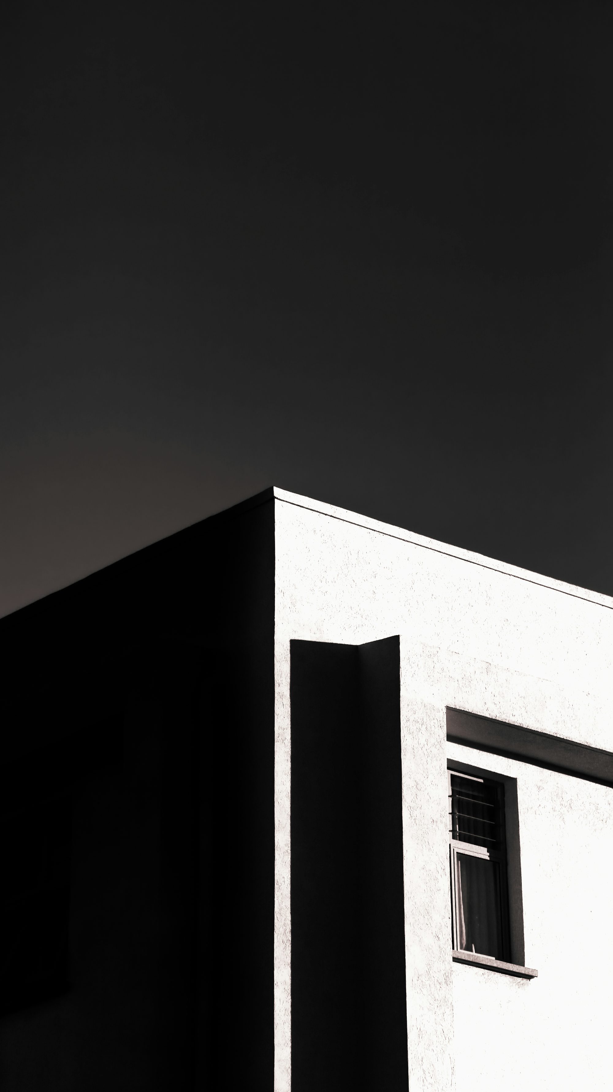 a black and white photo of a building with a window