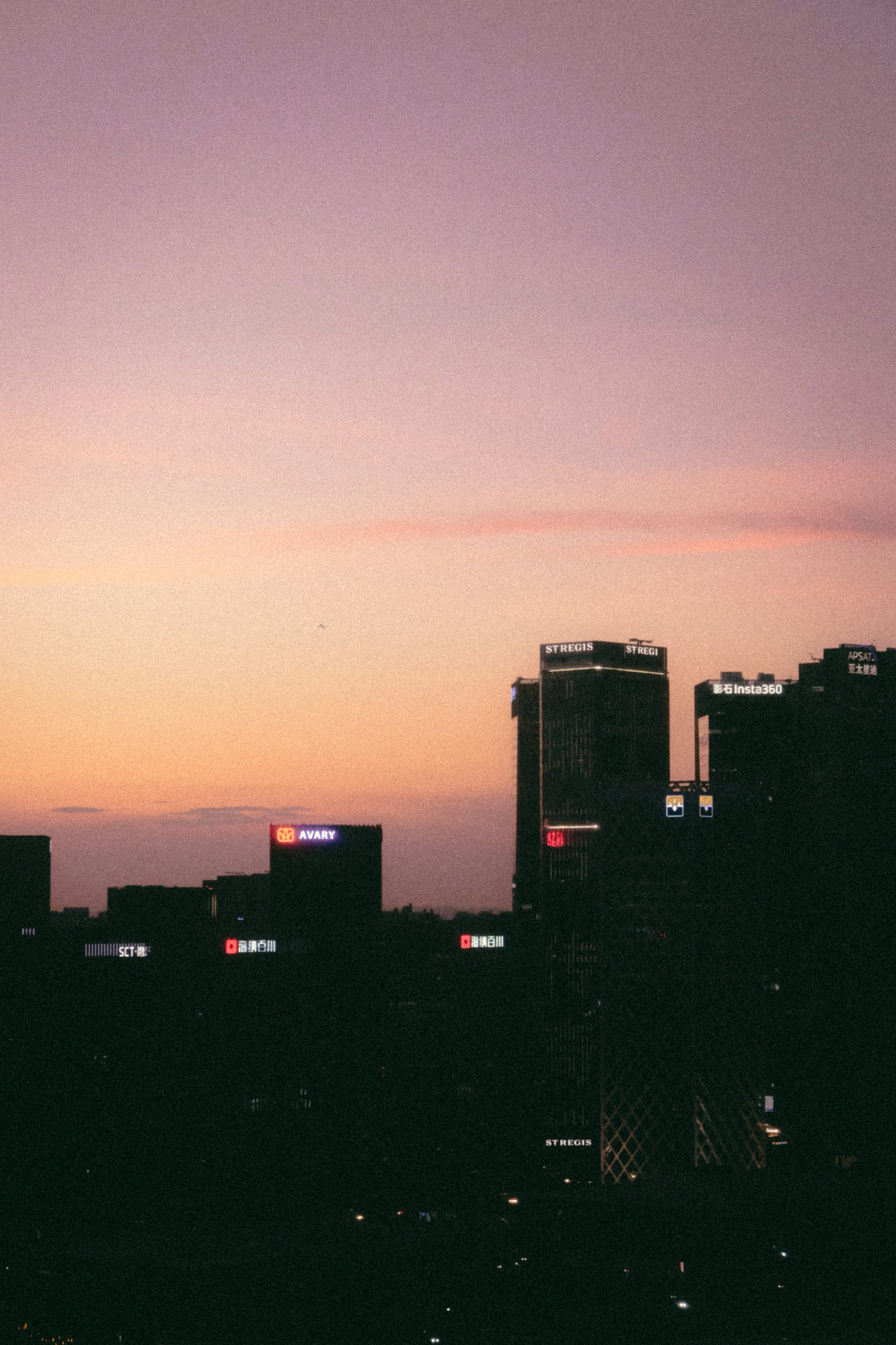 A view of a city skyline at sunset