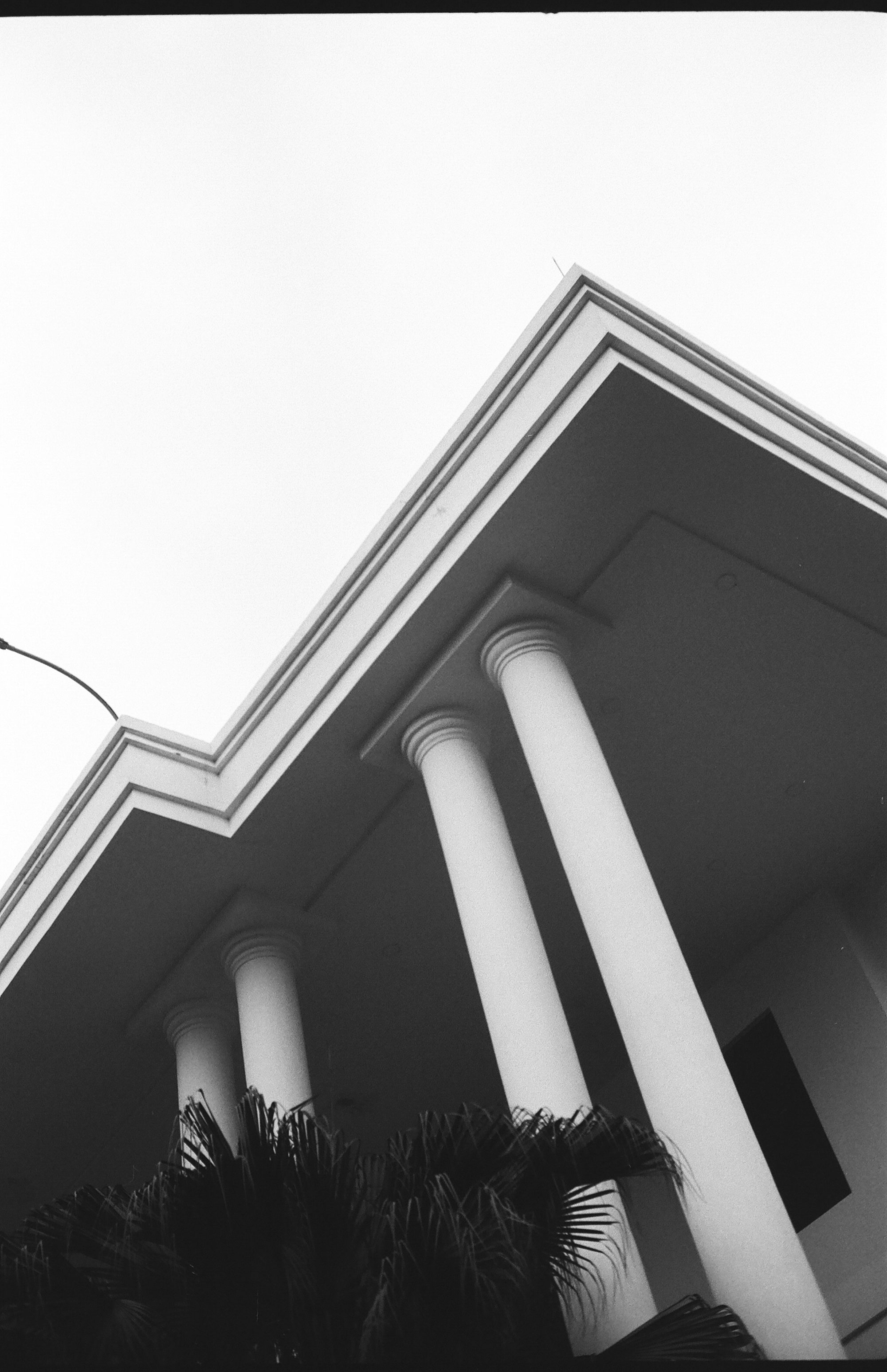 A black and white photo of a building with columns