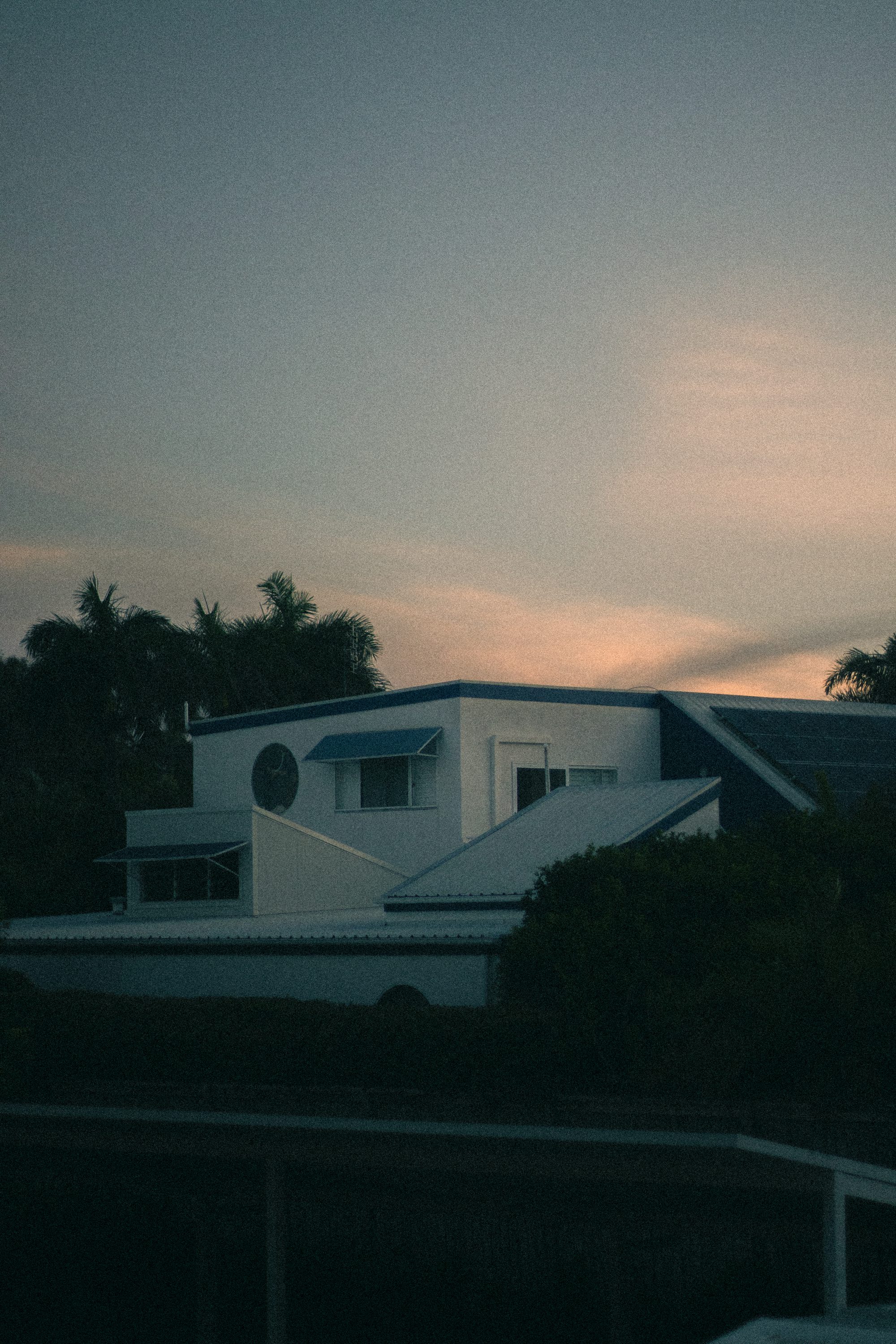 A white house sitting next to a body of water